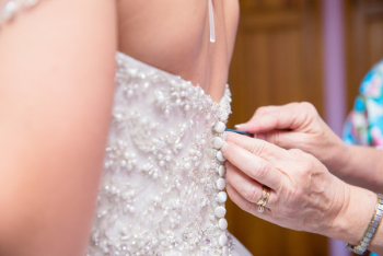 Person Fixing Woman&#39;s Dress