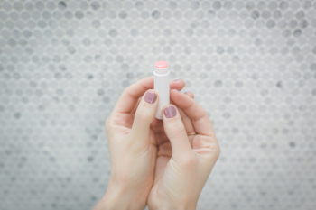 Person Holding a lip balm Person Holding a lip balm