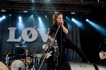 Person Holding a Microphone While Singing at Stage