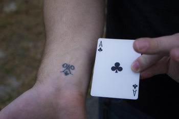 Person Holding Ace of Club Playing Card Person Holding Ace of Club Playing Card