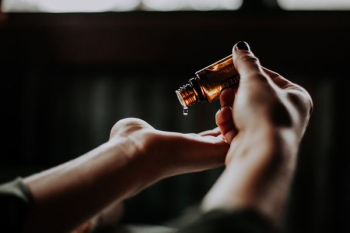 person holding amber glass bottle person holding amber glass bottle