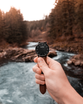 Person Holding Analog Watch Displaying 3:36