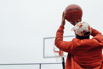 person holding basketball looking at basketball hoop system person holding basketball looking at basketball hoop system