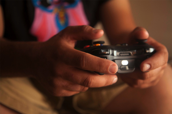 Person Holding Black Game Controller Person Holding Black Game Controller