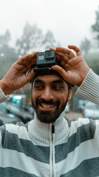 Person Holding Black Gopro Action Camera Person Holding Black Gopro Action Camera