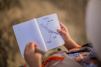 Person Holding Black Lined Paper Person Holding Black Lined Paper
