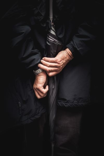 person holding black umbrella person holding black umbrella