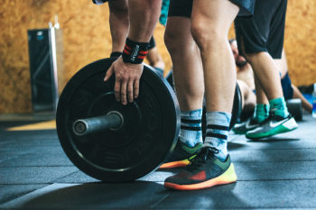 Person Holding Black Weight Plates Person Holding Black Weight Plates
