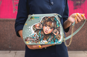 Person Holding Blue Crossbody Bag