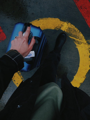 Person Holding Blue Luggage Person Holding Blue Luggage