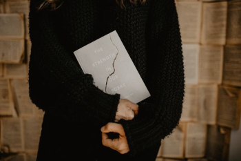 person holding book person holding book