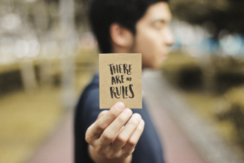 Person Holding Brown Card Person Holding Brown Card