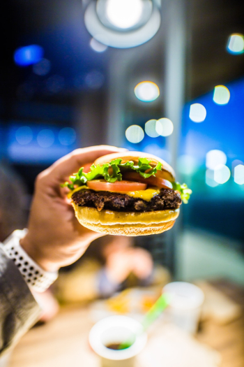 Person Holding Burger Person Holding Burger