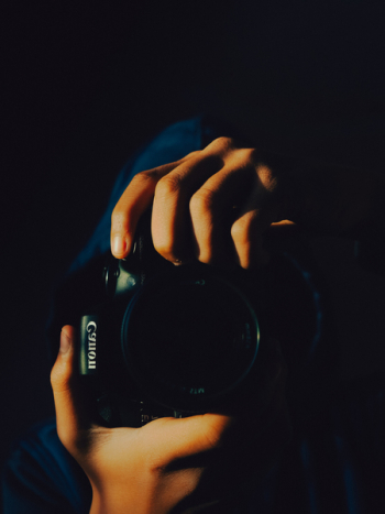 Person Holding Canon Camera Person Holding Canon Camera