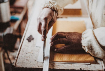 person holding chisel while carving wood person holding chisel while carving wood