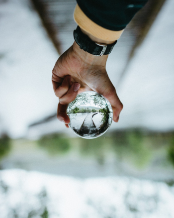 Person Holding Clear Glass Ball Person Holding Clear Glass Ball