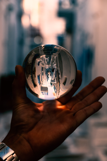 Person Holding Clear Glass Ball Person Holding Clear Glass Ball