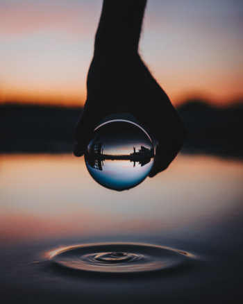 Person Holding Clear Glass Ball Person Holding Clear Glass Ball