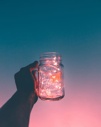 person holding clear glass mug jar person holding clear glass mug jar