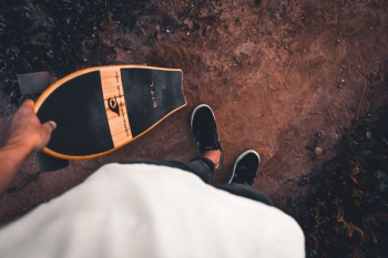 person holding cruiser board person holding cruiser board