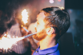 Person Holding Fireworks by Mouth