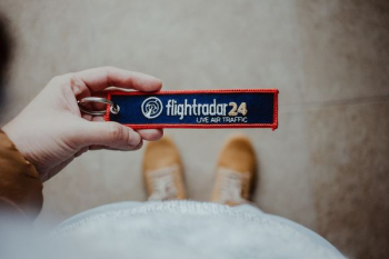 person holding Flightradar 24 card person holding Flightradar 24 card