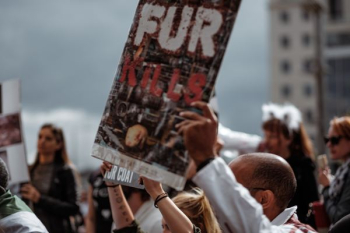 person holding Fur Kills poster person holding Fur Kills poster