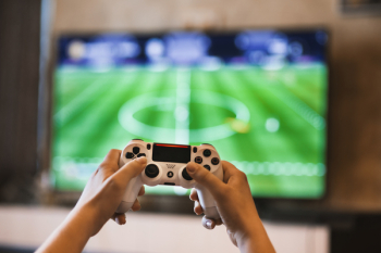 Person Holding Game Pads Person Holding Game Pads