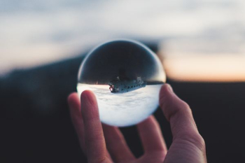 person holding glass ball person holding glass ball