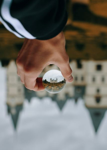 person holding glass ball person holding glass ball