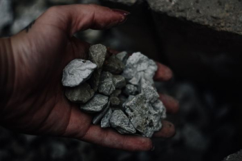 person holding gravel stones person holding gravel stones
