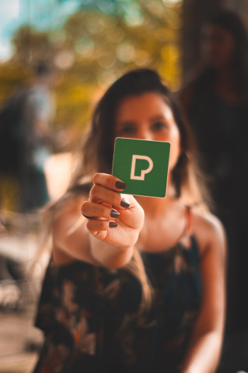 Person Holding Green P Card Person Holding Green P Card