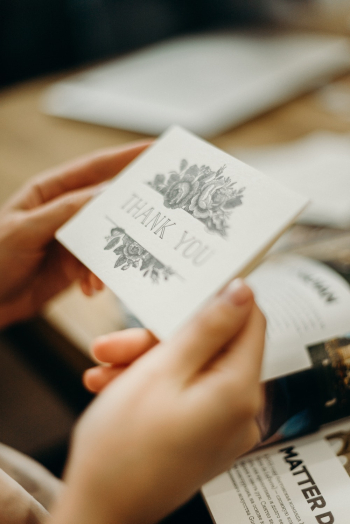 Person Holding Grey and Gold Card Person Holding Grey and Gold Card