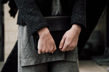 person holding handbag person holding handbag