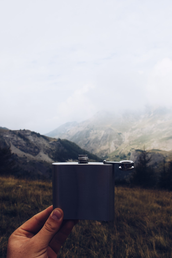 Person Holding Hip Flask Person Holding Hip Flask