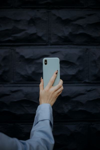 person holding iPhone X person holding iPhone X