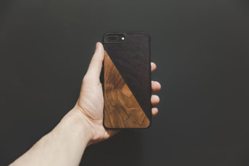 person holding jet black iPhone 7 Plus person holding jet black iPhone 7 Plus