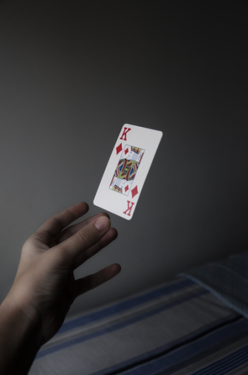 Person Holding King of Diamonds Playing Card Person Holding King of Diamonds Playing Card