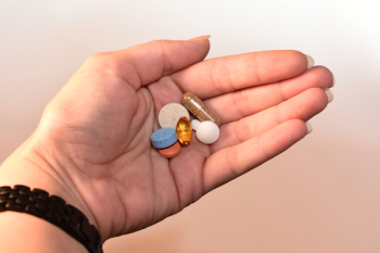 Person Holding Medication Pill and Capsules Person Holding Medication Pill and Capsules