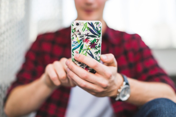 Person Holding Multicolored Floral Iphone Case Person Holding Multicolored Floral Iphone Case