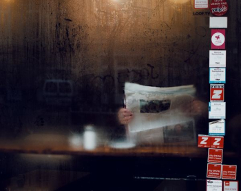 person holding newspaper person holding newspaper