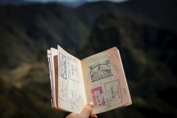 person holding passport person holding passport
