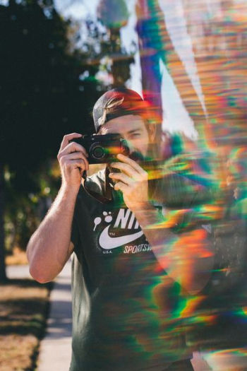 person holding point-and-shoot camera person holding point-and-shoot camera