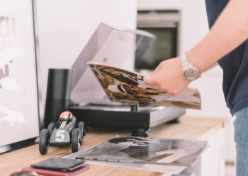 person holding record sleeve person holding record sleeve
