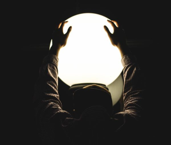 person holding round glass window person holding round glass window