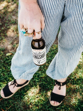 person holding slingshot bottle