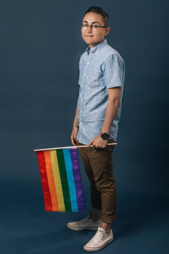 Person Holding Small Pride Flag Portrait Person Holding Small Pride Flag Portrait