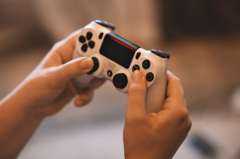 Person Holding Sony Ps4 Controller Person Holding Sony Ps4 Controller