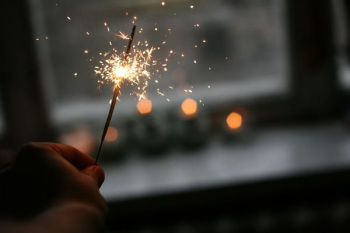 person holding sparkler person holding sparkler