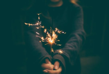 person holding sparkler person holding sparkler